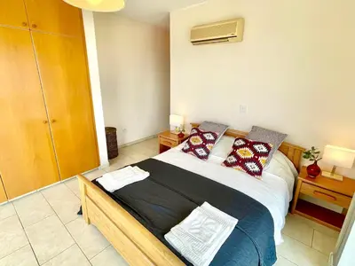 a bedroom with a large bed with pillows on it at Stunning villa with breathtaking sea view in Pissouri