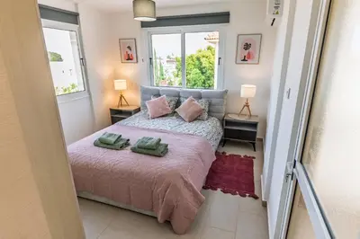 a bedroom with a bed with two green towels on it at Thea Court 3 - E in Paralimni