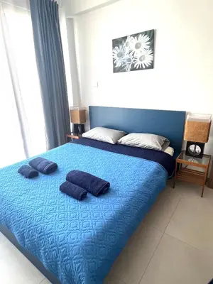 a bedroom with a blue bed with two pillows on it at Unique 2 storey apt city centre in Larnaka