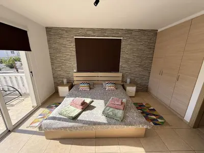 a bedroom with a large bed and a large tv at Nissia Bella 1 - A in Ayia Napa