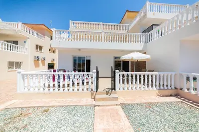 a white house with a white picket fence at Nissia Bella 1 - A in Ayia Napa