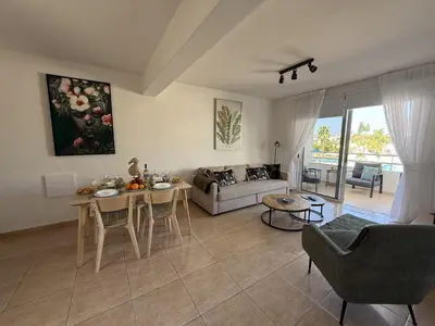a living room with a couch and a table at Nissi 3, 1 -B in Ayia Napa