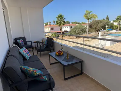 a living room with a couch and a table at Nissi 3, 1 -B in Ayia Napa