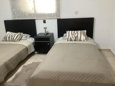 a bedroom with two beds and a window at Urban Nest - near GSP & General Hospital in Laxia