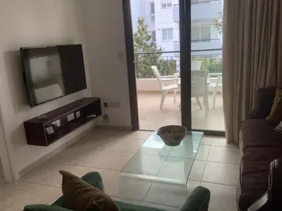 a living room with a tv and a couch at Urban Nest - near GSP & General Hospital in Laxia