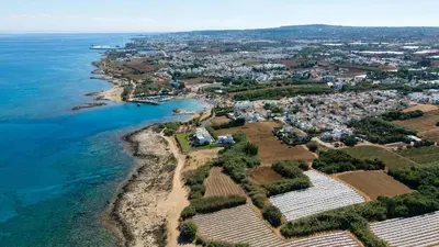 an aerial view of a village next to the ocean at Ayia Triada Beach Gardens in Protaras