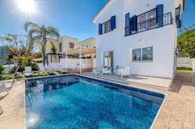 a villa with a swimming pool and a house at Blue Horizon Villa in Protaras