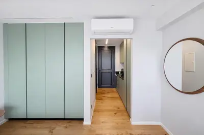 a hallway with glass doors and a mirror at Sky Suites Nicosia in Strovolos