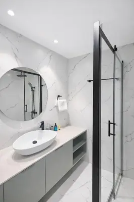 a white bathroom with a sink and a mirror at Sky Suites Nicosia in Strovolos