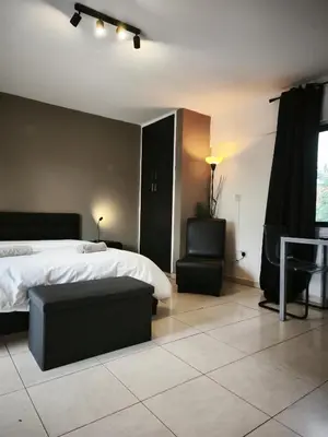 a bedroom with a bed and a chair and a couch at 103 St Lazaros View Studio in Larnaka