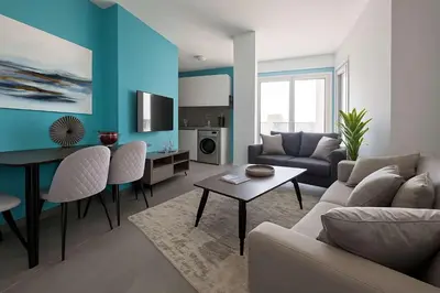 a living room with a couch and a table at Modern 1BR with City View in Central Larnaca in Larnaka