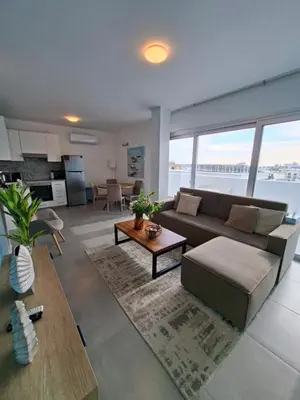 a living room with a couch and a table at Luxury central 1BR with city view in Larnaka