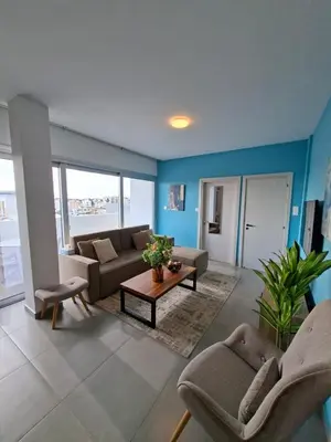 a living room with a couch and a table at Luxury central 1BR with city view in Larnaka