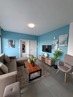 a living room with a couch and a table at Luxury central 1BR with city view in Larnaka