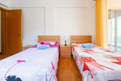 two beds sitting next to each other in a room at STAY Hillcrest Panorama Villa in Moniatis