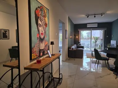 a living room with a large painting of a woman at Pop Art Residence by Staycom in Nicosia