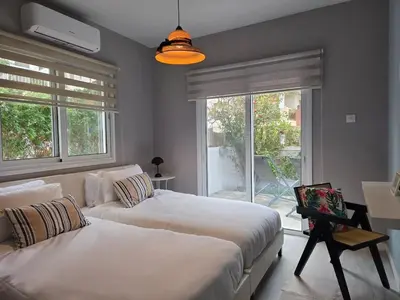 a bedroom with two beds and a large window at Pop Art Residence by Staycom in Nicosia