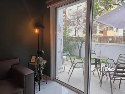 a sliding glass door leading to a patio with a table and chairs at Pop Art Residence by Staycom in Nicosia