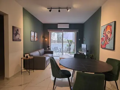 a living room with a couch and a table and chairs at Pop Art Residence by Staycom in Nicosia