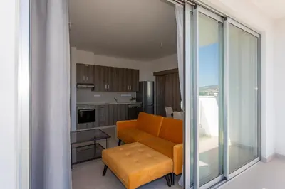 a living room with a couch and a table at BlueBell Limassol Suites in Limassol