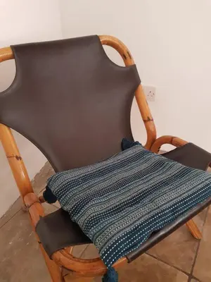 a black chair with a pillow on it at Cottage Studio Zoe in Psematismenos