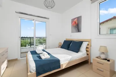 a bedroom with a bed and a large window at Villa Anais - 3-Bed Villa with Private Pool in Paralimni