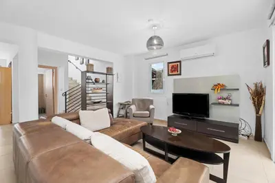 a living room with a couch and a table at Villa Anais - 3-Bed Villa with Private Pool in Paralimni