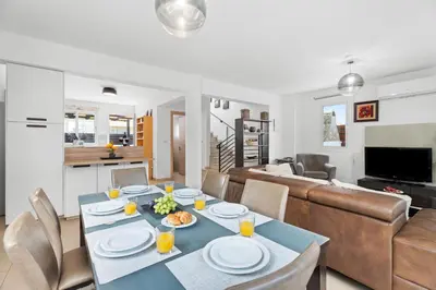 a living room with a table and a couch at Villa Anais - 3-Bed Villa with Private Pool in Paralimni