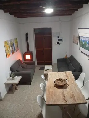 a living room with a table and a couch at En chirokitia cottages in Chirokitia