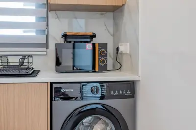 a washing machine sitting on top of a counter at TelMar White House - 100m from the Sea in Voroklini