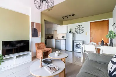 a living room with a couch and a table at Odin 1-BR Apartment & Balcony in Larnaca in Larnaka