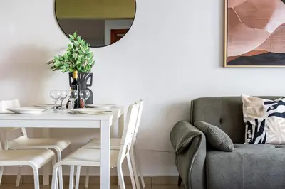 a dining room with a table and a chair at Odin 1-BR Apartment & Balcony in Larnaca in Larnaka