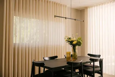 a dining room table with chairs and a vase of flowers at Pinewood by Holistays in Engomi