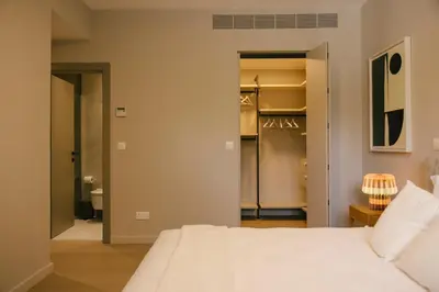 a bedroom with a white bed and a closet at Pinewood by Holistays in Engomi