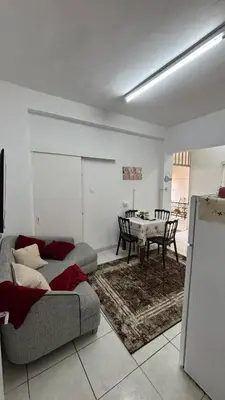 a living room with a couch and a table at Coast & City Apartment in Limassol