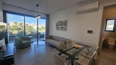 a living room with a couch and a glass table at STAY Engomi Gem 1 in Engomi
