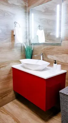 a bathroom with a red vanity with a white sink at K-Apartments Managed by Quattro Forze Group in Larnaka