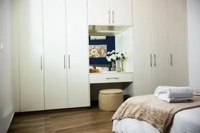 a bedroom with white cabinets and a bed at K-Apartments Managed by Quattro Forze Group in Larnaka