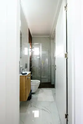 a bathroom with a shower and a toilet and a sink at Cozy 1BR Apartment with Terrace in Phrenaros