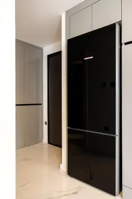 an empty room with a large black refrigerator at Panorama Comfort Suita in Protaras