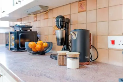 a kitchen counter with a juicer and a bowl of oranges at TelMar Port Sea View - 10 minutes walk from Finikoudes in Larnaka