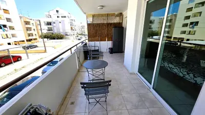 a balcony with a table and chairs on a building at 2 Apartments Retreat with Pool & Free Wi-Fi in Larnaka