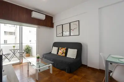 a living room with a couch and a glass table at Palmove Makenzy Charming 1Bed Apt in Larnaka