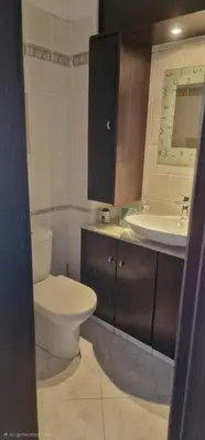 a bathroom with a toilet and a sink at 3 Bedroom Penthouse Livadia Larnaca in Livadhia