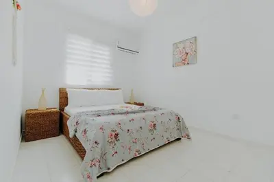 a bedroom with a bed with a floral bedspread at Private Bungalow with private pool and parking in Alsancak Kyrenia North Cyprus in Phikardhou