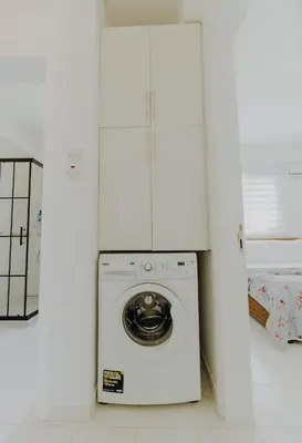 a washing machine in a room with white walls at Private Bungalow with private pool and parking in Alsancak Kyrenia North Cyprus in Phikardhou