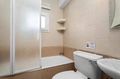 a bathroom with a shower and a toilet and a sink at Villa St George - 3 Bed Villa with Private Pool in Xylophaghou