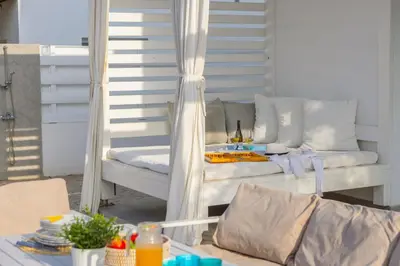 a porch with a chair and a table with at Protaras Villa Alina in Protaras