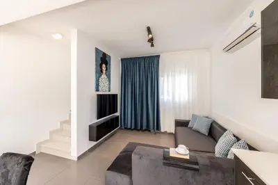 a living room with a couch and a table at Protaras Villa Alina in Protaras