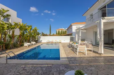 a swimming pool in the backyard of a house at Protaras Villa Alina in Protaras